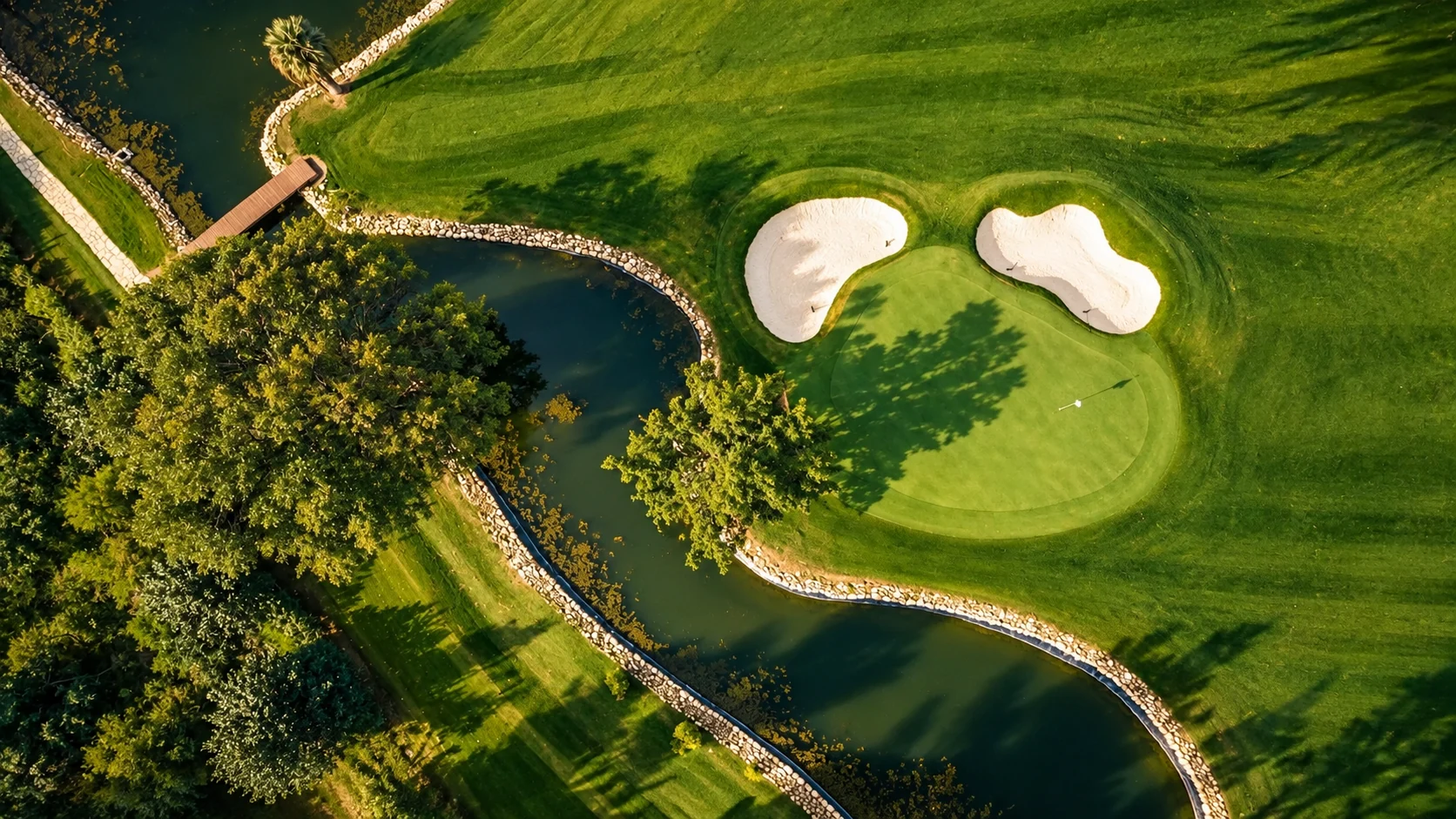 Presentation aerial view of a green and water feature at BANÚS